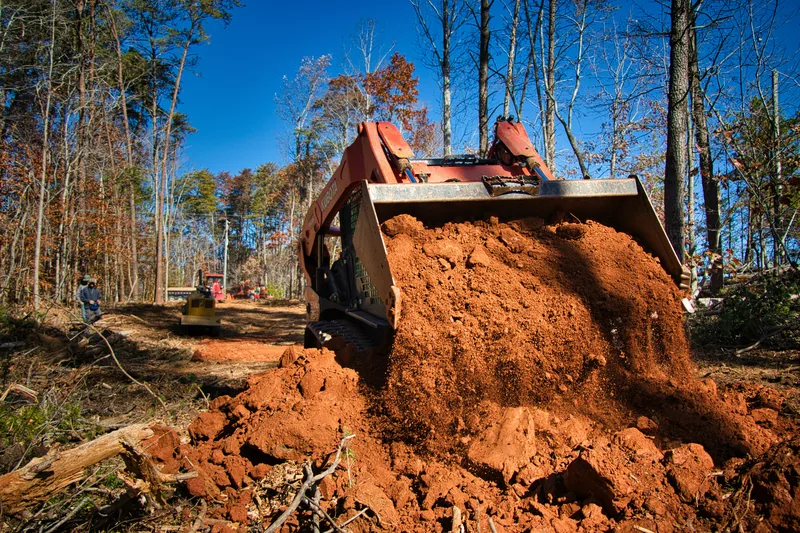 Tracked bulldozer pushing soil during land clearing and site preparation